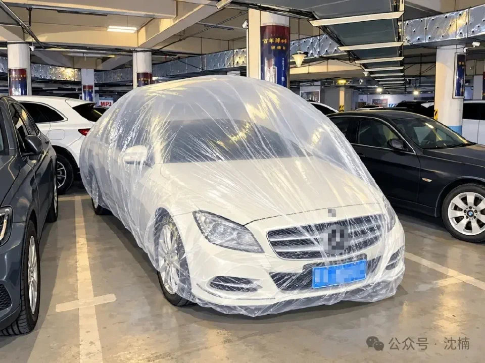 A transparent car cover puffed up like a balloon